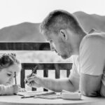 parent teaching girl how to write